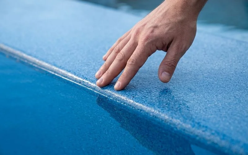 Hand touching Diamond Brite surface — smooth texture