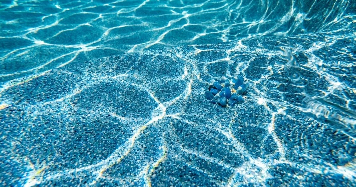 Blue Diamond Brite pool finish close-up with polished quartz texture